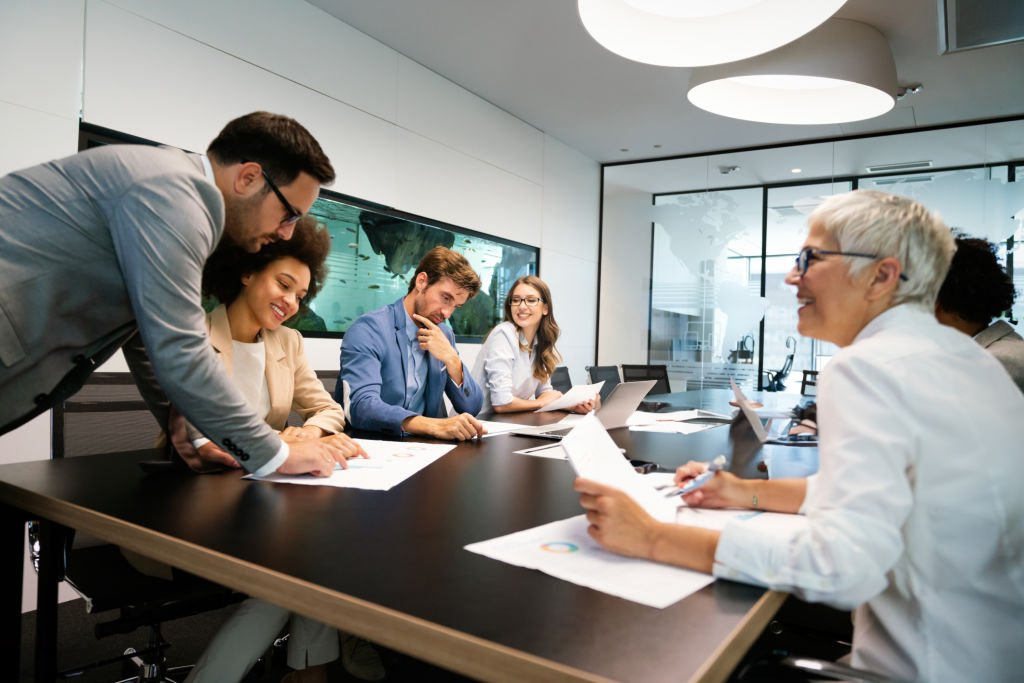 Diverse group of business professionals collaborating in a meeting room.